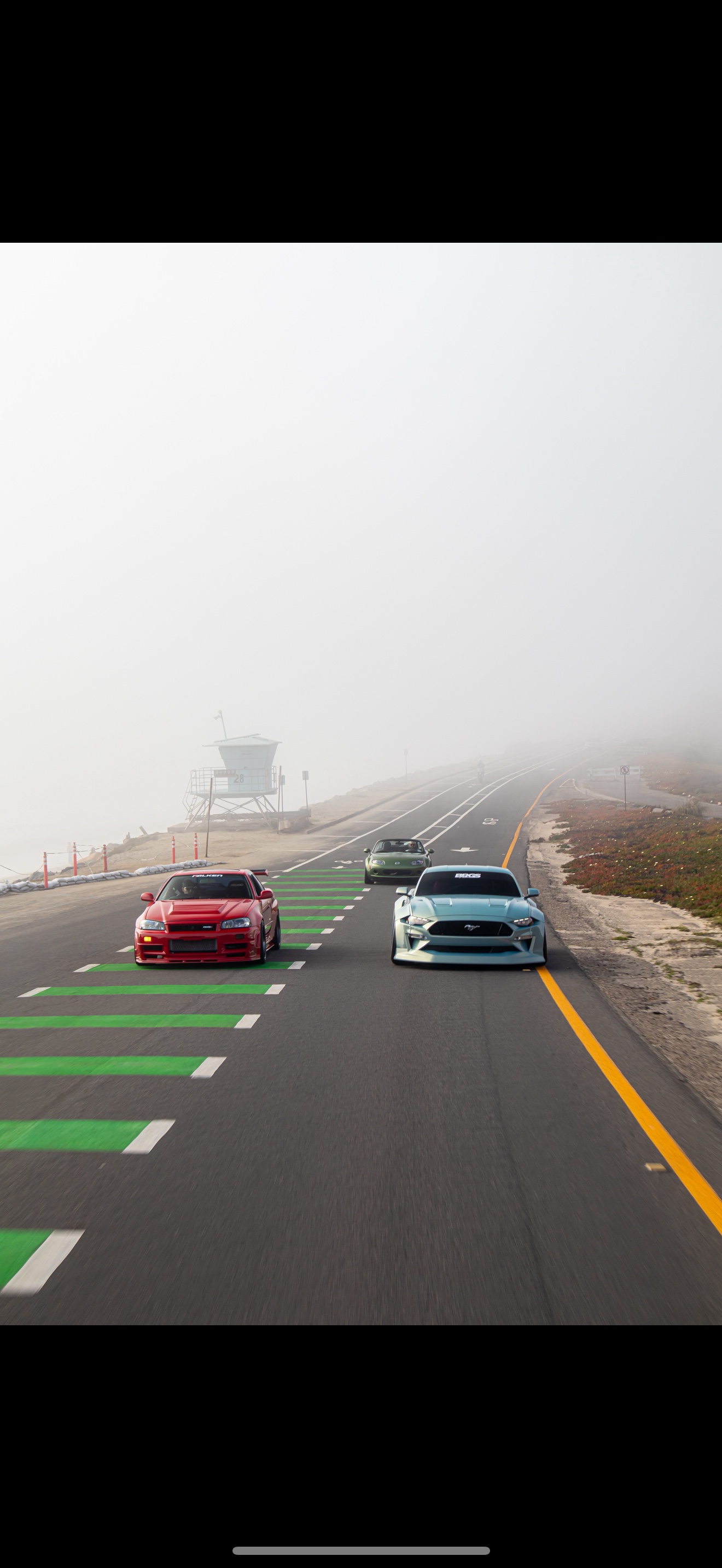Foggy coastal highway with R34 Skyline and Mustang running in formation