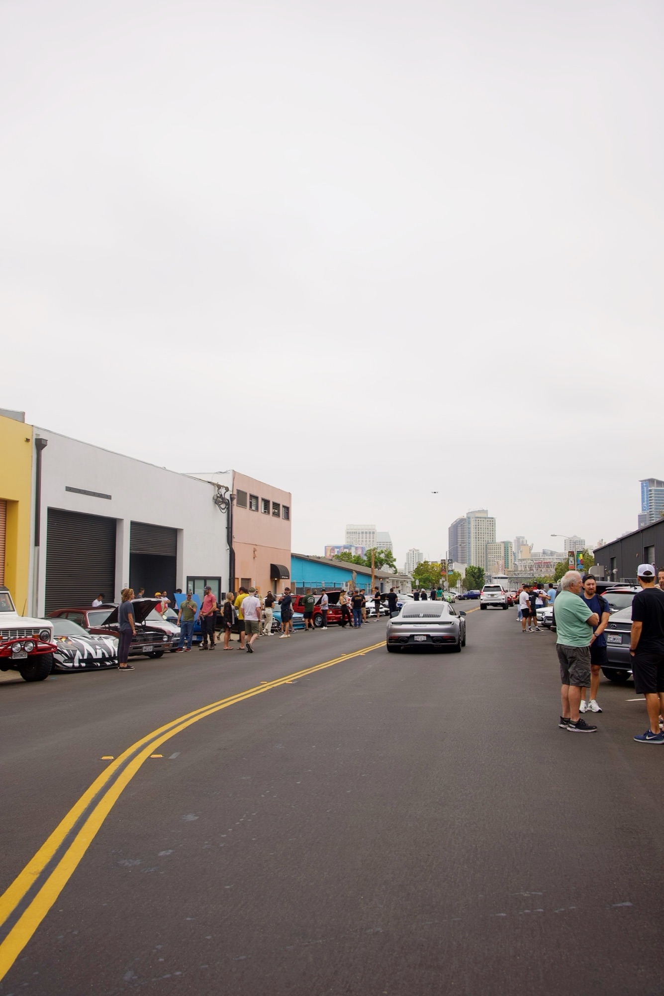 Urban cars-and-coffee with city skyline